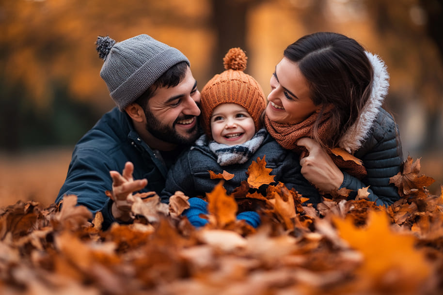 Happy family enjoying autumn leaves in a park, symbolizing warmth, togetherness, and seasonal festivities. Visit the Eternal Slots blog for ideas on Thanksgiving activities, holiday-themed promotions, and ways to celebrate special moments with loved ones.