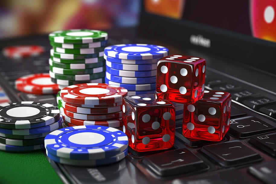 Stacks of colorful poker chips and red dice on a laptop keyboard, representing online casino gaming and online casino tournaments at Eternal Slots Casino.