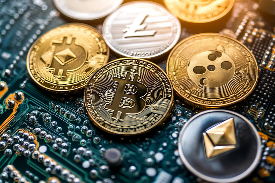 A collection of Bitcoin and altcoins placed on a computer motherboard, emphasizing the integration of blockchain technology in gaming and finance.