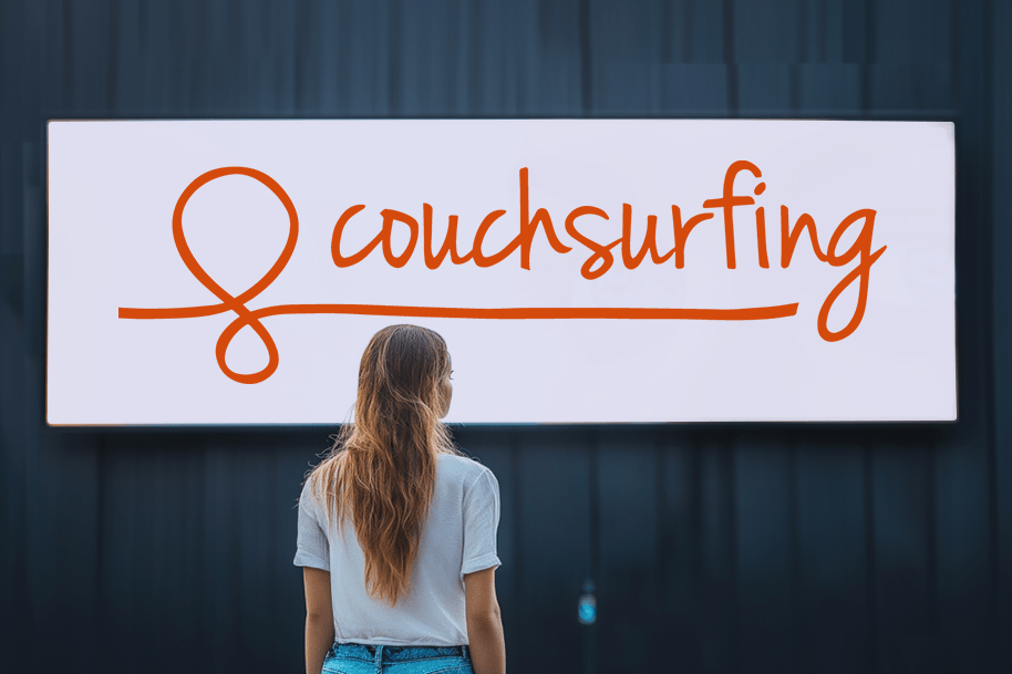 Backpacker staring at a billboard with the Couchsurfing logo – highlighting budget travel, local hosting, and community-based accommodation experiences.