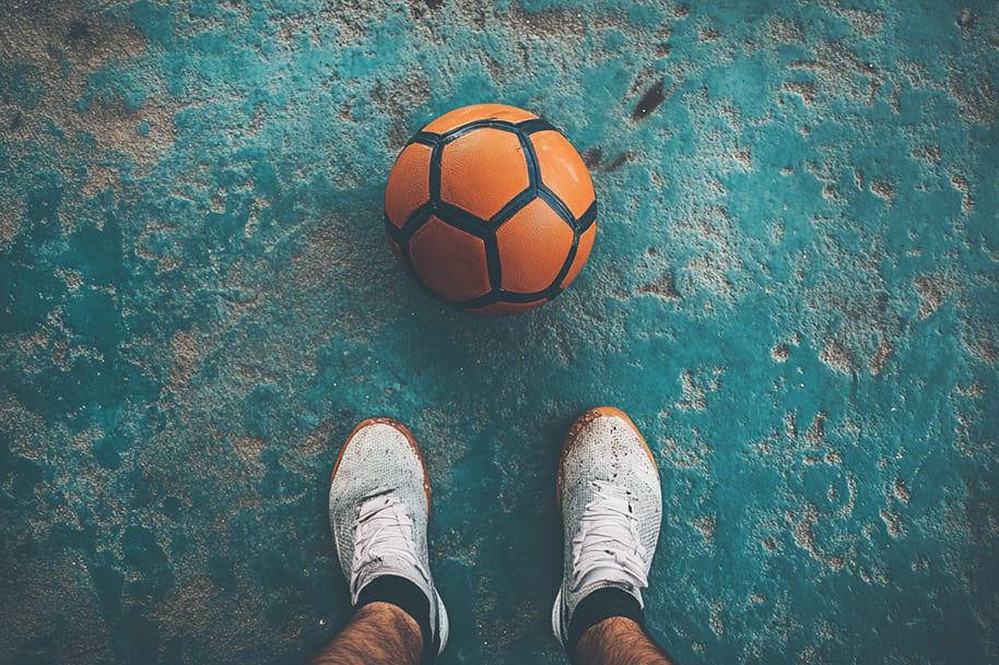 Soccer-themed image showing athletic shoes and ball highlighting the foundation of sports discipline and training routines.