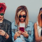 Group of Gen Z players focused on mobile screens exploring trending casino games and instant payout options at EternalSlots online casino.