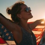 Woman celebrating Independence Day at sunset holding American flag – perfect 4th of July vacation vibe for Eternal Slots Casino blog