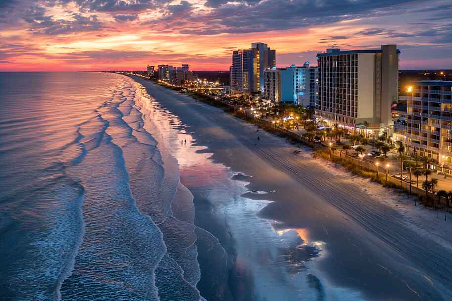 Night view of Myrtle Beach coastline and oceanfront hotels glowing under sunset skies top U.S. travel destination highlighted on EternalSlots.com casino blog