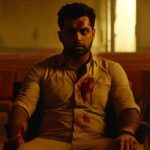 Blood-covered man sitting in empty room with intense expression – Scene from Indian psychological horror genre, Psych
