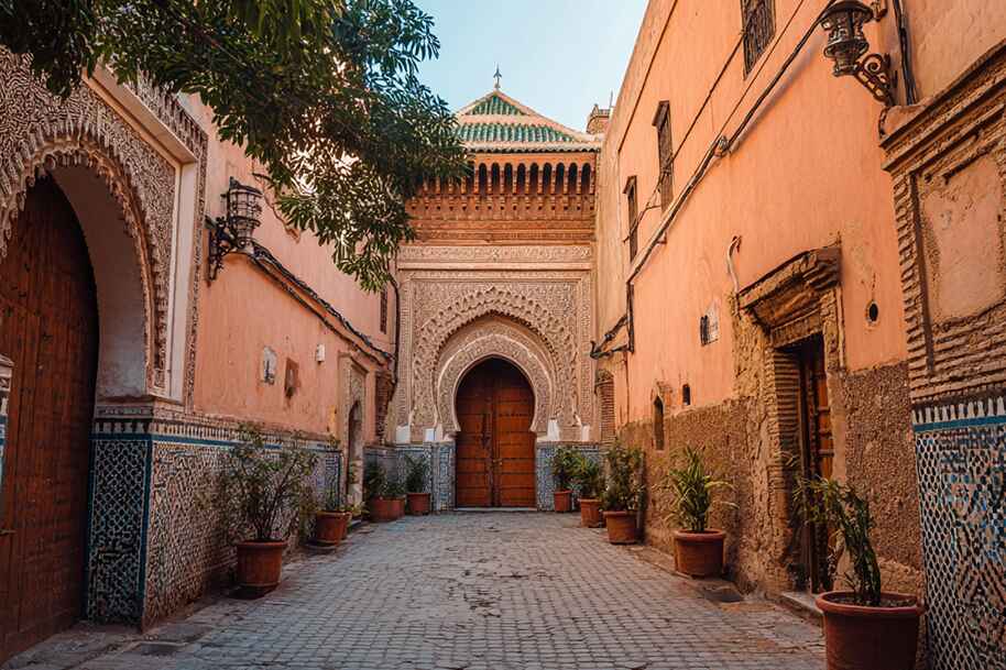 Beautiful entrance in the Marrakech medina with intricate Moroccan tilework and arches, must-see cultural site for 2025 travelers