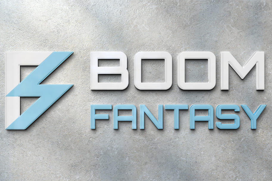 Boom Fantasy logo in blue and white on a stone-textured wall.