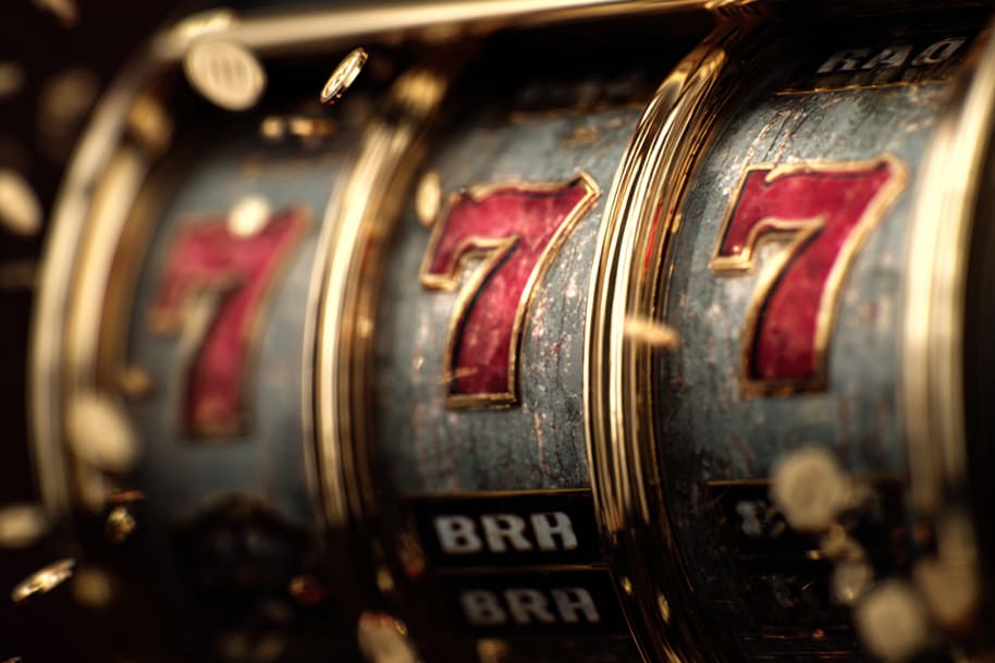 Triple 7s on classic slot machine with coins – grand jackpot payout in The Cash Is Right slot.