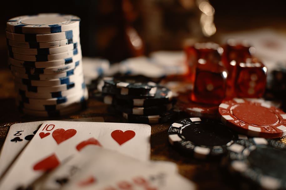 Poker cards and stacks of chips scattered on a casino table, capturing the thrill of gambling and high stakes