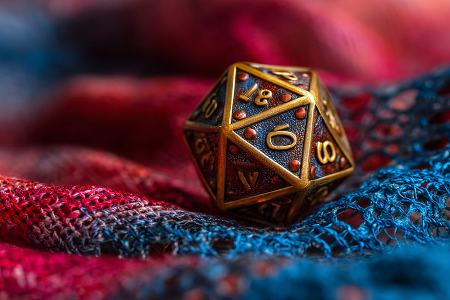 Colorful D20 dice on red and blue fabric – symbolic of numerology in July and personal destiny decisions.
