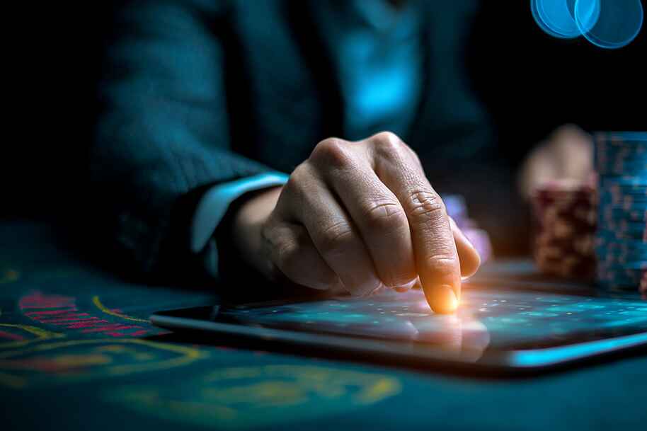 Close-up of a player using a tablet for online casino gaming with poker chips in the background, representing AI technology and smart bonuses at Eternal Slots Casino.