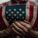 Close-up of elderly man holding a folded American flag during Labor Day celebrations in the US, symbolizing respect for workers and patriotic traditions.