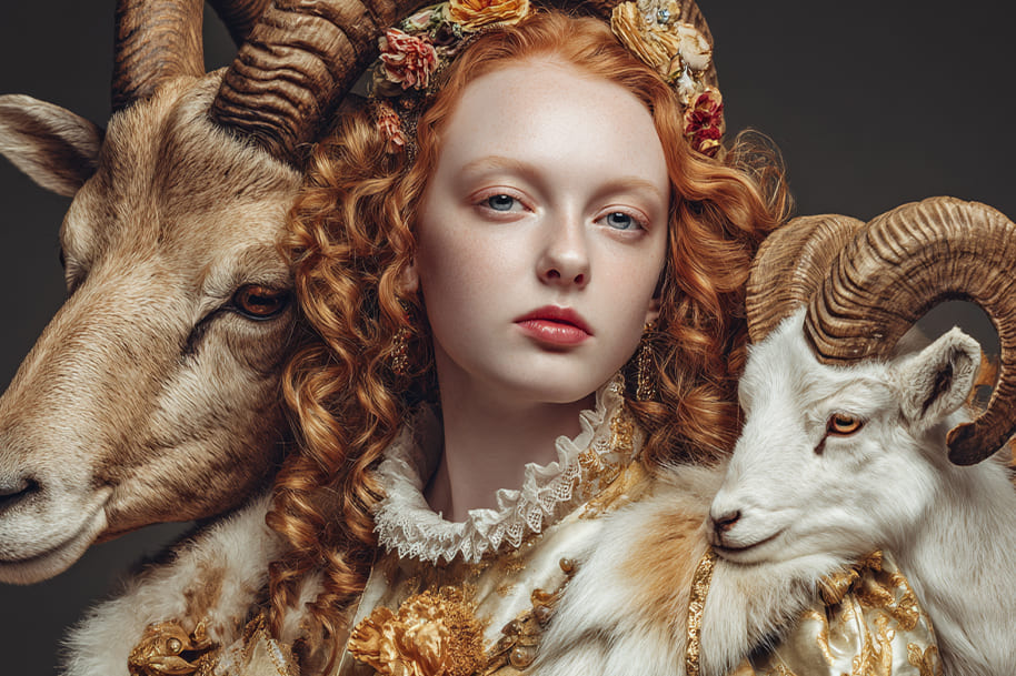 Symbolic portrait of a woman with two goats, representing Capricorn as one of the most ambitious zodiac signs, linked to career success and astrology.