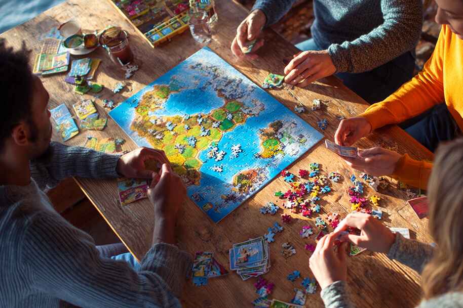 Friends playing board games and puzzles together – trending social hobby activity in 2025 highlighted on Eternal Slots blog