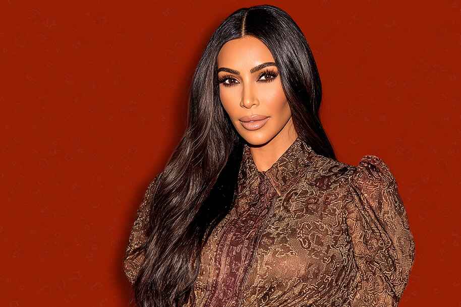 Kim Kardashian in elegant patterned dress against red background, highlighting her influence in fashion and business, Eternal Slots casino blog on her entrepreneurial journey.
