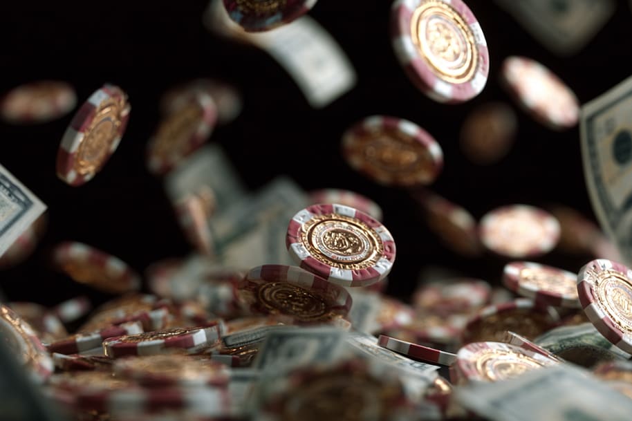 Falling casino chips and dollar bills representing the popularity of low wagering casino promotions.