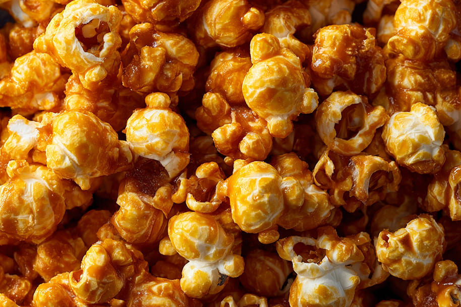Caramel popcorn coated with golden glaze, a light snack that satisfies sweet cravings without guilt.