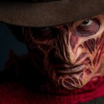 Horror villain with burnt face and brown hat wearing a red-striped sweater, symbolizing a nightmare character featured in a dark dating profile parody.