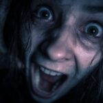 Terrified person screaming in a dark horror setting, capturing the thrill and fear of haunted house experiences during Halloween season.